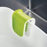 Cutlery cleaner brush stored on edge of sink