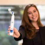 women displaying dual head toothbrush