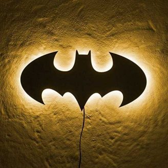 Batman LED Wall Light in yellow light hung on wall