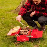 Toolbox-Barbeque-Grill being used to grill meats in a park